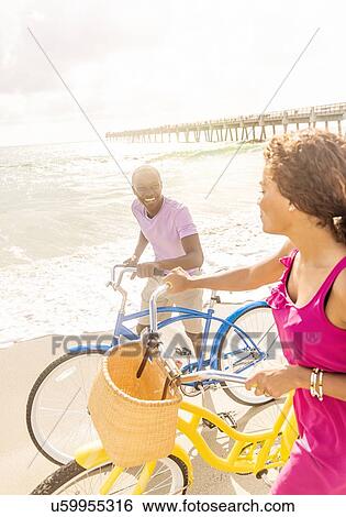 Stock Photograph - Young couple during bike trip. Fotosearch