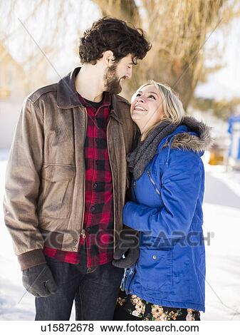 Young couple looking each other, smiling View Large Photo Image Stock Photo - Young couple looking each other, smiling. Fotosearch
