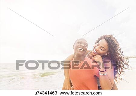 Young couple playing on beach View Large Photo Image Stock Image - Young couple playing on beach. Fotosearch