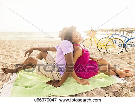 Young couple relaxing on beach View Large Photo Image Stock Photo - Young couple relaxing on beach. Fotosearch