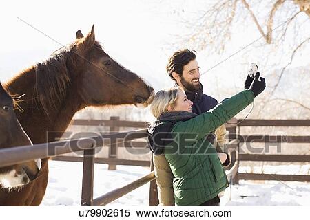Young couple self photographing View Large Photo Image Stock Photography - Young couple self photographing . Fotosearch