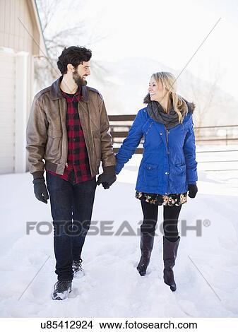 Picture - Young couple walking outdoors in winter. Fotosearch