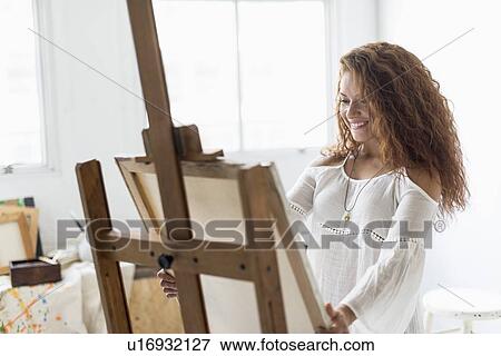 Young female artist in studio View Large Photo Image Stock Photo - Young female artist in studio. Fotosearch