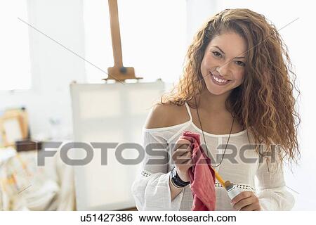 Young female artist in studio View Large Photo Image Stock Photograph - Young female artist in studio. Fotosearch