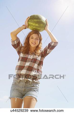 Young woman carrying on head watermelon View Large Photo Image Stock Photo - Young woman carrying on head watermelon. Fotosearch