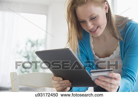 Young woman doing online shopping View Large Photo Image Stock Image - Young woman doing online shopping. Fotosearch