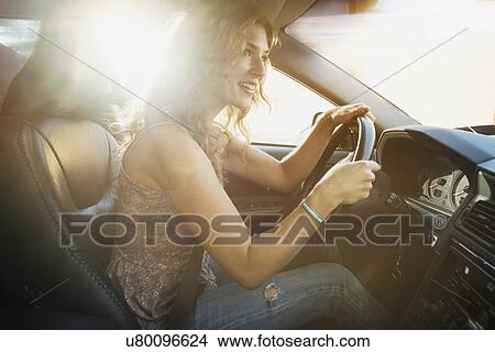 Picture - Young woman driving car. Fotosearch