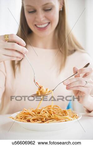 Young woman eating fettuccini View Large Photo Image Stock Image - Young woman eating fettuccini. Fotosearch