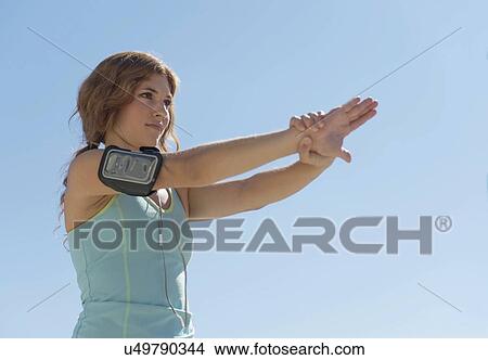 Picture - Young woman exercising. Fotosearch