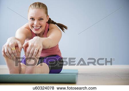 Stock Photo - Young woman exercising. Fotosearch