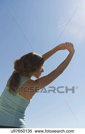 Stock Photography - Young woman exercising. Fotosearch