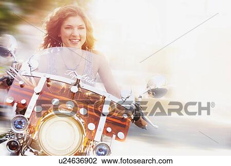 Young woman riding motorcycle View Large Photo Image Stock Image - Young woman riding motorcycle. Fotosearch