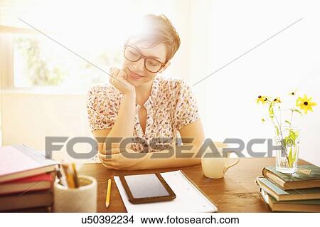 Young woman working in home office View Large Photo Image Picture - Young woman working in home office. Fotosearch