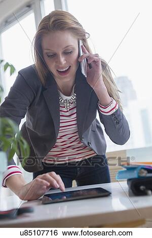 Young woman working View Large Photo Image Stock Photograph - Young woman working. Fotosearch