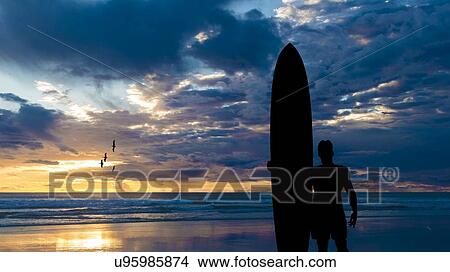 Picture - Longboarder silhouette at Oceanside. Fotosearch