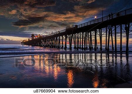 Picture - Oceanside pier at sunset under clouds. Fotosearch