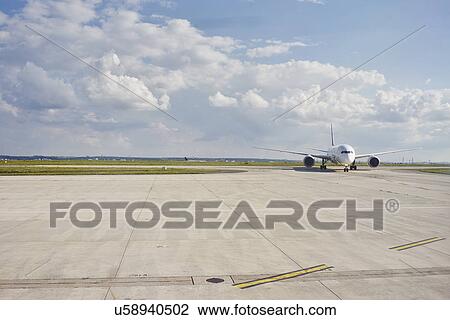 Stock Image - Airplane on runway, Paris, France. Fotosearch