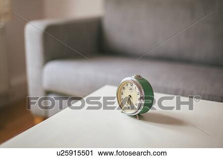 Alarm clock on coffee table in living room View Large Photo Image Stock Image - Alarm clock on coffee table in living room. Fotosearch