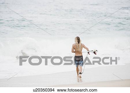 Australian surfer with surfboard on beach View Large Photo Image Picture - Australian surfer with surfboard on beach. Fotosearch