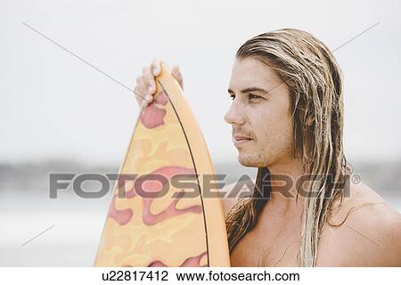 Stock Image - Australian surfer with surfboard. Fotosearch