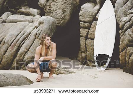 Stock Image - Australian surfer with surfboard, Bacocho, Puerto Escondido, Mexico. Fotosearch