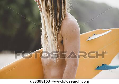 Stock Image - Australian surfer with surfboard. Fotosearch