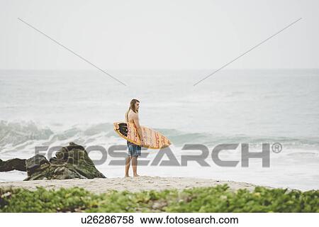 Stock Photo - Australian surfer with surfboard, Bacocho, Puerto Escondido, Mexico. Fotosearch