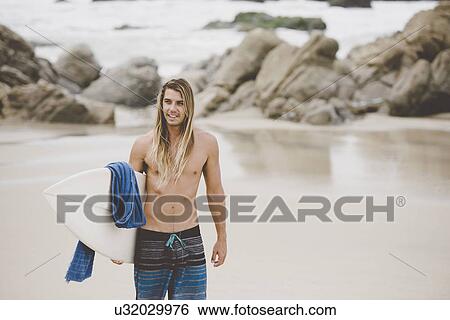 Stock Photograph - Australian surfer with surfboard, Bacocho, Puerto Escondido, Mexico. Fotosearch