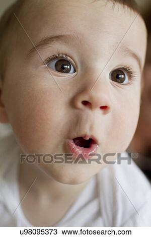 Stock Image - Baby boy making facial expressions. Fotosearch