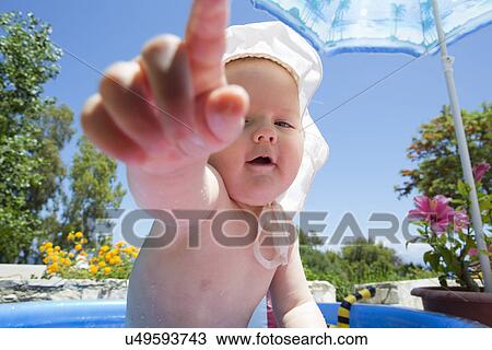Baby girl in swimming pool pointing finger View Large Photo Image Stock Image - Baby girl in swimming pool pointing finger. Fotosearch