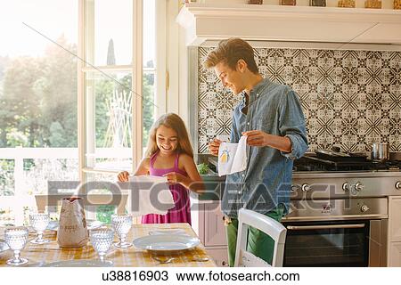 Brother and sister setting kitchen table View Large Photo Image Stock Image - Brother and sister setting kitchen table. Fotosearch