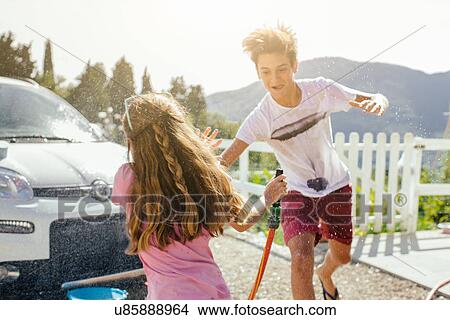 Brother and sister washing car View Large Photo Image Picture - Brother and sister washing car. Fotosearch