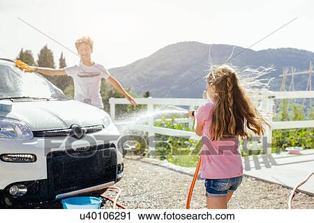 Brother and sister washing car View Large Photo Image Stock Image - Brother and sister washing car. Fotosearch