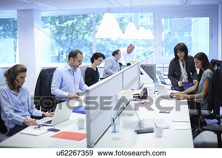 Business team at their desks in busy office View Large Photo Image Stock Photo - Business team at their desks in busy office. Fotosearch