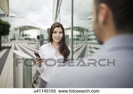 Stock Photography - Businesswoman holding cell phone. Fotosearch