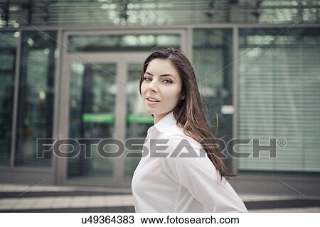 Stock Image - Businesswoman wearing white shirt, portrait. Fotosearch