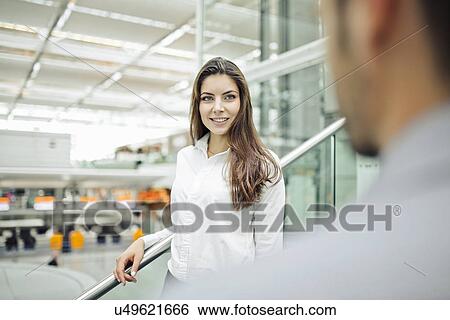 Stock Photograph - Businesswoman wearing white shirt, smiling. Fotosearch