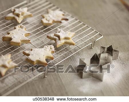 Close up of freshly baked christmas biscuits on cooling rack View Large Photo Image Stock Photo - Close up of freshly baked christmas biscuits on cooling rack. Fotosearch