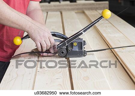 Close up of male warehouse worker fastening wooden planks in hardware store View Large Photo Image Stock Image - Close up of male warehouse worker fastening wooden planks in hardware store. Fotosearch