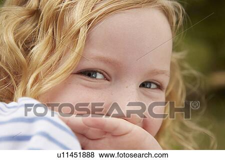 Close up portrait of girl with hand covering mouth View Large Photo Image Stock Photo - Close up portrait of girl with hand covering mouth. Fotosearch