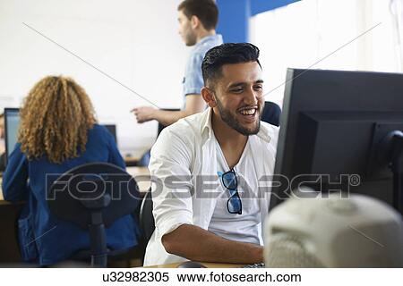 Stock Photography - College students using personal computers in classroom. Fotosearch