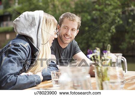 Stock Image - Couple having lunch by canal. Fotosearch
