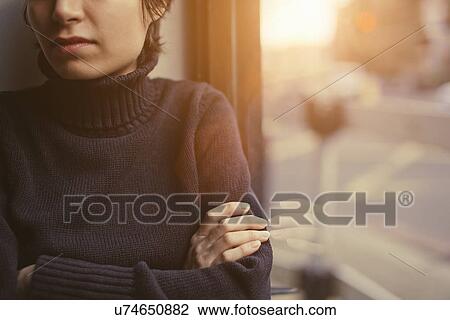 Cropped portrait of young woman with arms folded next to window View Large Photo Image Stock Image - Cropped portrait of young woman with arms folded next to window. Fotosearch