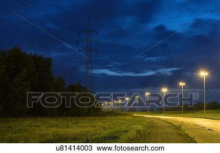 Stock Image - Empty road near Antwerp harbour at night, Antwerp, Belgium. Fotosearch