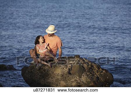 Father and daughter, sitting on rock in sea, Costa Brava, Catalonia, Spain View Large Photo Image Stock Image - Father and daughter, sitting on rock in sea, Costa Brava, Catalonia, Spain. Fotosearch