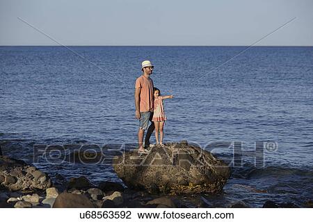 Father and daughter standing on rock in sea, Costa Brava, Catalonia, Spain View Large Photo Image Stock Image - Father and daughter standing on rock in sea, Costa Brava, Catalonia, Spain. Fotosearch