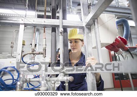 Female engineer checking factory pipes View Large Photo Image Stock Photo - Female engineer checking factory pipes. Fotosearch
