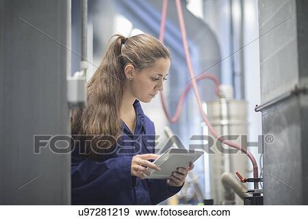 Female engineer checking factory machinery using digital tablet View Large Photo Image Stock Photo - Female engineer checking factory machinery using digital tablet. Fotosearch