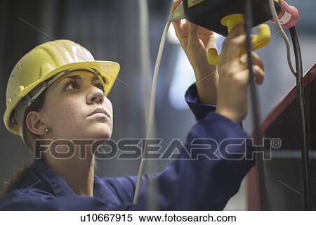 Female engineer checking valves and cables in factory View Large Photo Image Stock Photography - Female engineer checking valves and cables in factory. Fotosearch