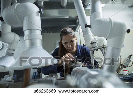 Female engineer turning pipe valves in factory View Large Photo Image Stock Photo - Female engineer turning pipe valves in factory. Fotosearch